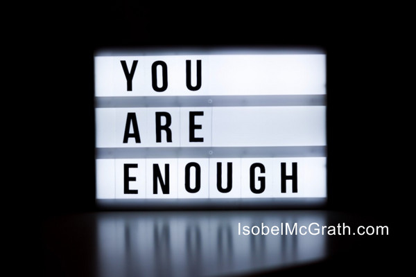 backlit sign with the words "You Are Enough"